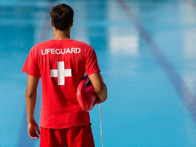 Lifeguard watches water and thinks about lifeguard tips